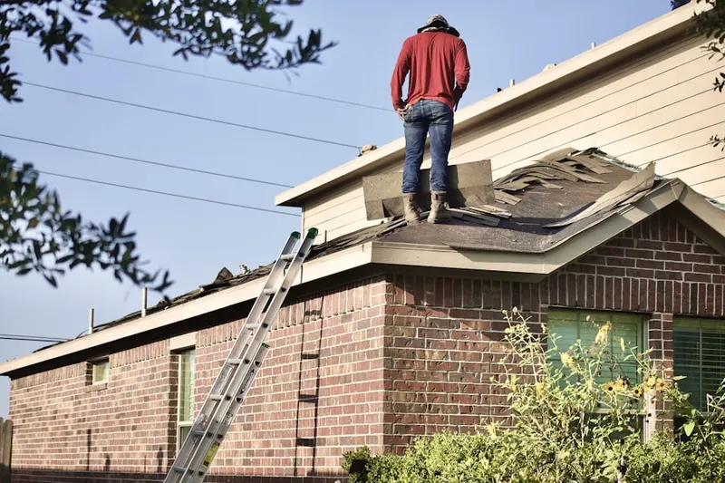 Professional roofer working on a residential roof in The Landing at Tradition